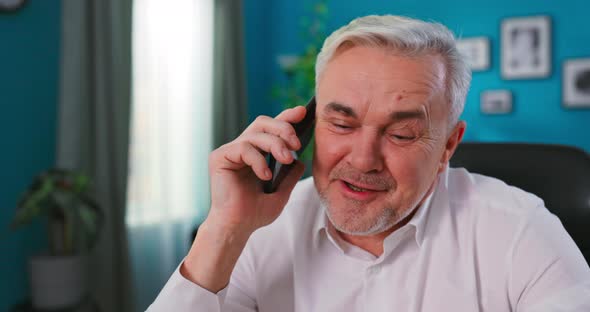 Close Up Portrait of Excited Elderly Senior Chatting Sharing News on Mobile Phone with Grown