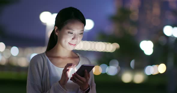 Woman use of cellphone at night