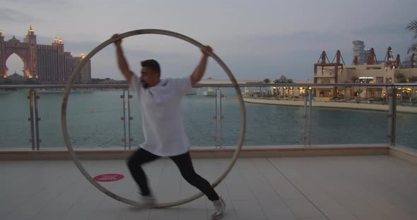 Atlantis Hotel in the Background of a Man Doing Wheel Gymnastics