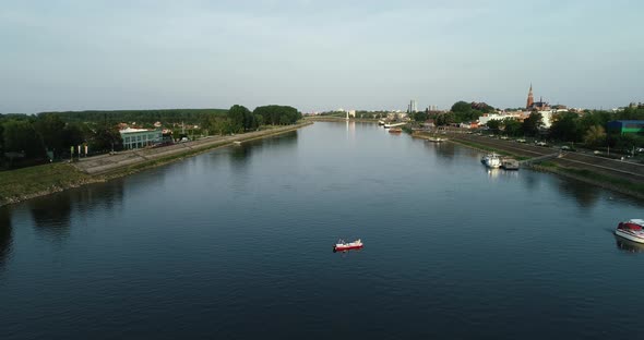 Aerial view of a small boat crossing Drava river at sunset, Osijek, Croatia.