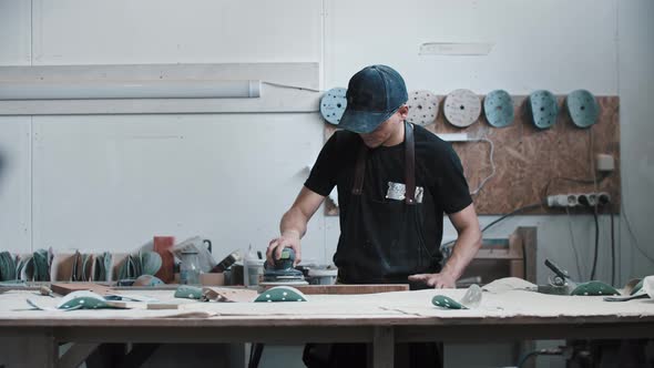 Man Worker Grinding a Wooden Piece with a Circular Saw