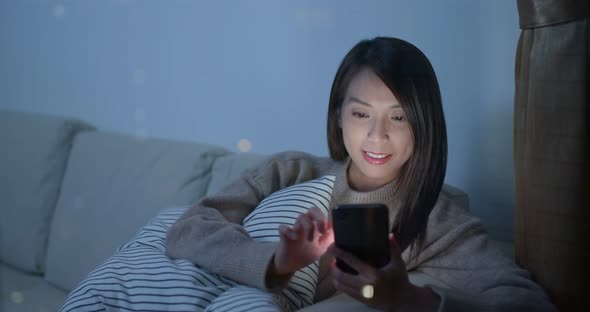 Woman look at mobile phone at night