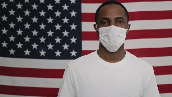 Static video of man with face mask on American flag. Shot with RED helium camera in 8K