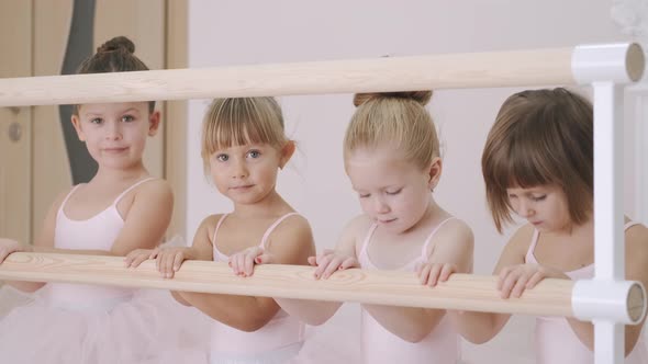 Little African Girl Practicing Choreographic Elements on Ballet Barre