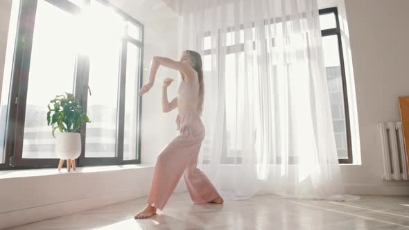 Street Dancing  Young Slim Woman Dances in White Spacious Room