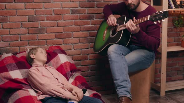 Father Playing Guitar with His Son