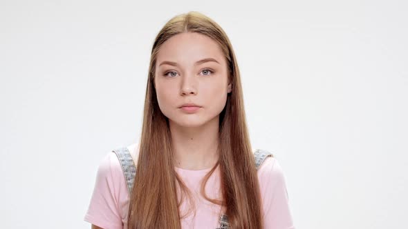 Sad Young Beautiful Girl Sighing Over White Background