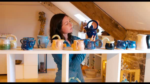 Woman looking at earthenware pot