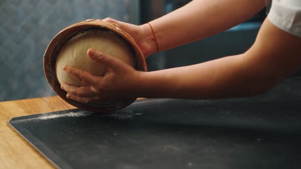 Man kneading dough with his hands to make bread