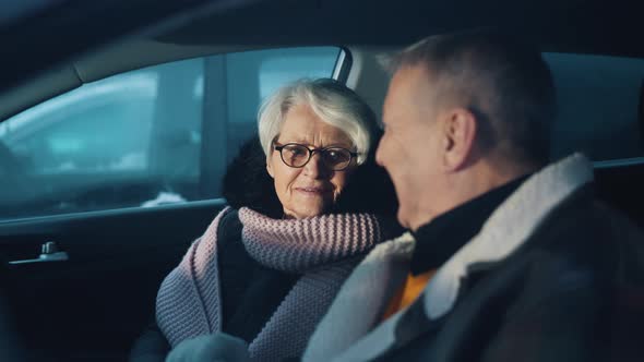 Elderly Couple Checking GPS in Their New Car