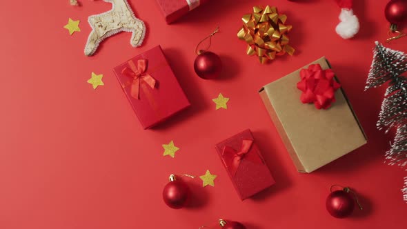Christmas decorations with presents and copy space on red background
