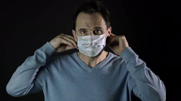 Man Puts on Medical Mask, Inscription nCoV-2019. Coronavirus Outbreak in Europe