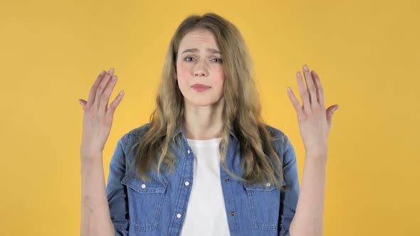 Young Pretty Girl Gesturing Failure and Problems on Yellow Background