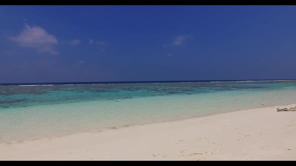 Aerial flying over panorama of luxury resort beach voyage by transparent ocean with white sandy back