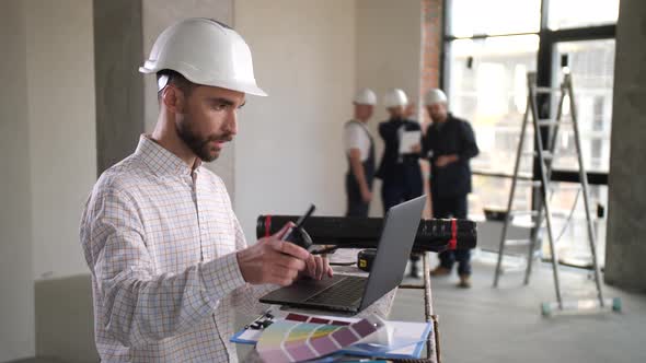 Male Engineer Talking Walkietalkie During Work