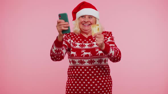 Mature Christmas Grandmother Woman Use Mobile Cell Phone Plastic Credit Bank Card Win Calebrate Wow