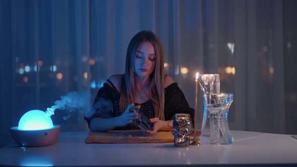 Woman Reading Tarot Cards in Spiritual Room