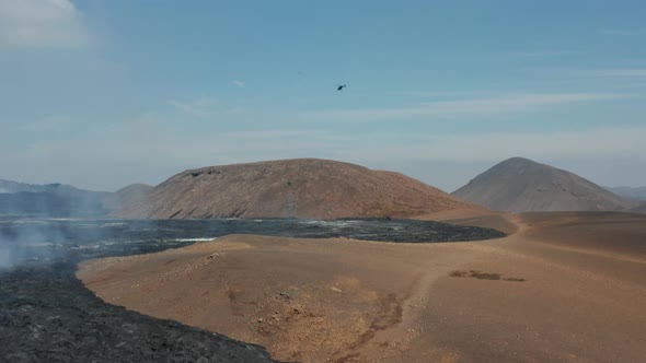 Helicopter Observing Above Volcanic Landscape After Eruption