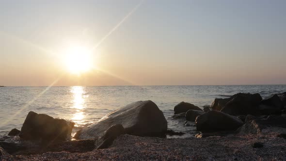 beautiful sunrise over the sea. foreground stone backgrounds