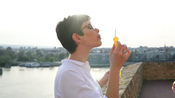 Beautiful Woman Blowing Dreamy Soap Bubbles