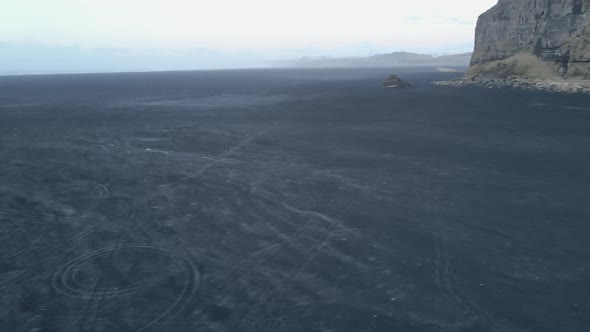 Tracking Shot of Cliff Sandy Horizon and Mountain Silhouettes  Iceland