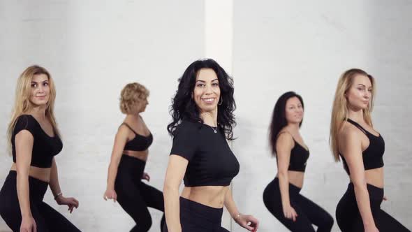 Group of Female Dancers Learning How to Move Their Bodies When Dancing Bachata