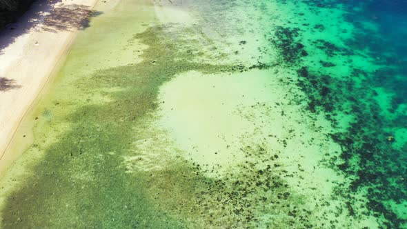 Sea texture with coral reefs growing under calm clear water of shallow lagoon near shore of tropical