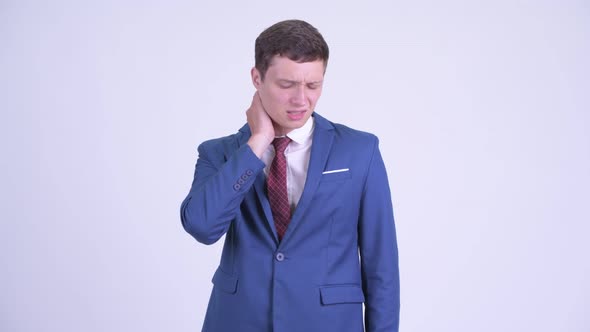 Stressed Young Businessman Having Neck Pain