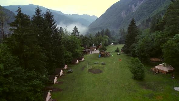 Aerial view of forest wooden cabins at an excursion camp in Soca river.