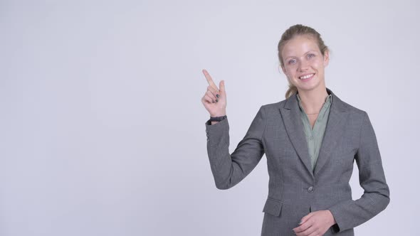 Young Happy Blonde Businesswoman Thinking and Pointing Up