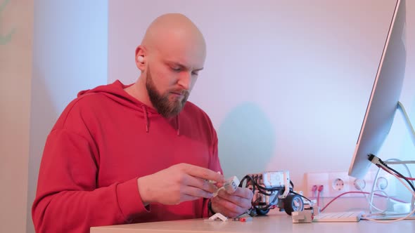 Close Up of a Robotics Teacher Hands Online Course for His Students Using a Robot