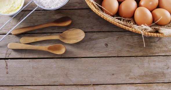 Brown eggs and baking soda on wooden table 4k