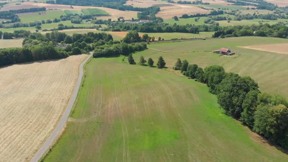 drone flying over farmland with shed