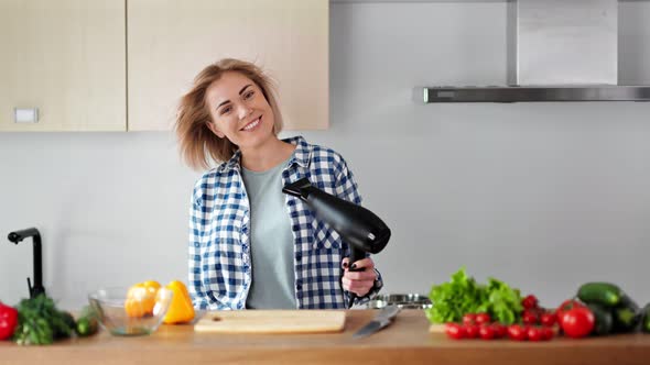 Beautiful Young Housewife Singing Song and Dancing During Drying Hair with Blow Dryer at Kitchen