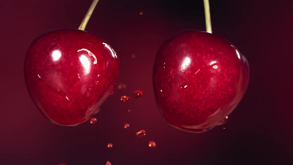 Sweet Cherries on Stems Colliding and Splashing Juice Droplets in Slow Motion