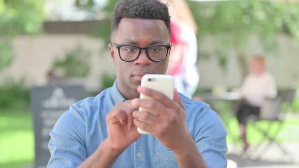 Portrait of African Man Using Smartphone