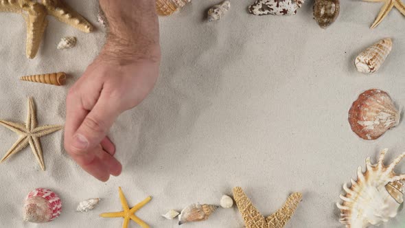 Man's Hand is Clearing the Sand Demonstrating Advertising Area Workspace Mock Up