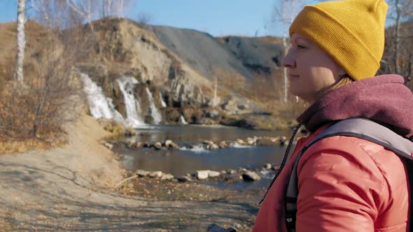 Woman Hiker Stands Against Waterfall