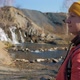 Woman Hiker Stands Against Waterfall - VideoHive Item for Sale