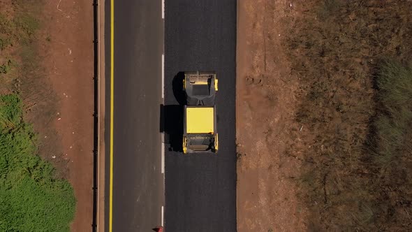 New road paving pressed by a road roller, Top down aerial view.