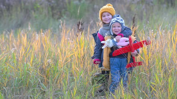 Happy family children kid together on the autumn field.