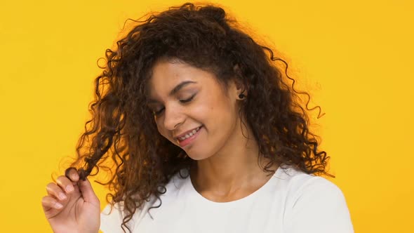 Playful Girl Twisting Curls on Finger, Flirting at Camera, Unruly Hair Problem