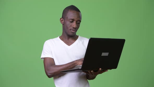 Young African Man Using Laptop