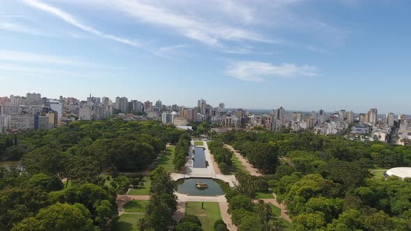 Park in center of city. Green area surrounded by a city. Blue sky with clouds. Aerial scene. Porto A