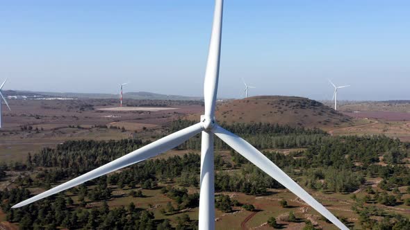 Wind turbines spin in a rural mountain landscape, Aerial view.