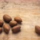Hard shell pecan nuts are falling onto textured bark paper - stop motion - VideoHive Item for Sale