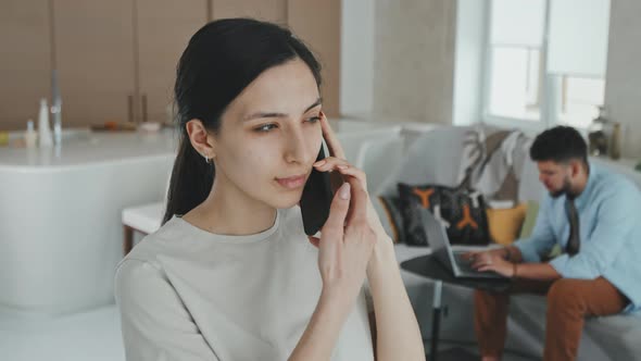 Young Beautiful Woman Talking On Phone At Home