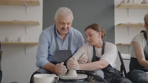 A Woman Master Shares Her Skills with a Senior Man Conducting a Lesson for the Elderly