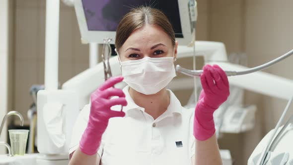 A Female Dentist Id Showing the Dentist Drills