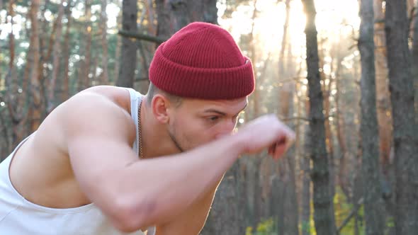 Portrait of Tired Runner Taking Break After Hard Run Workout in Forest. Athletic Guy Resting After